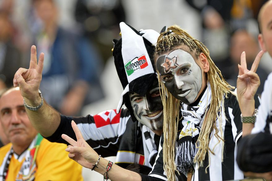 Juventus supporters celebrate their team's victory of the overall soccer title prior to the start of a Serie A soccer match between Juventus and Atalanta, at the Juventus stadium, in Turin, Italy, Monday, May 6, 2014. Juventus won its 30th title three rounds ahead of the end of the championship. (AP Photo/Massimo Pinca)