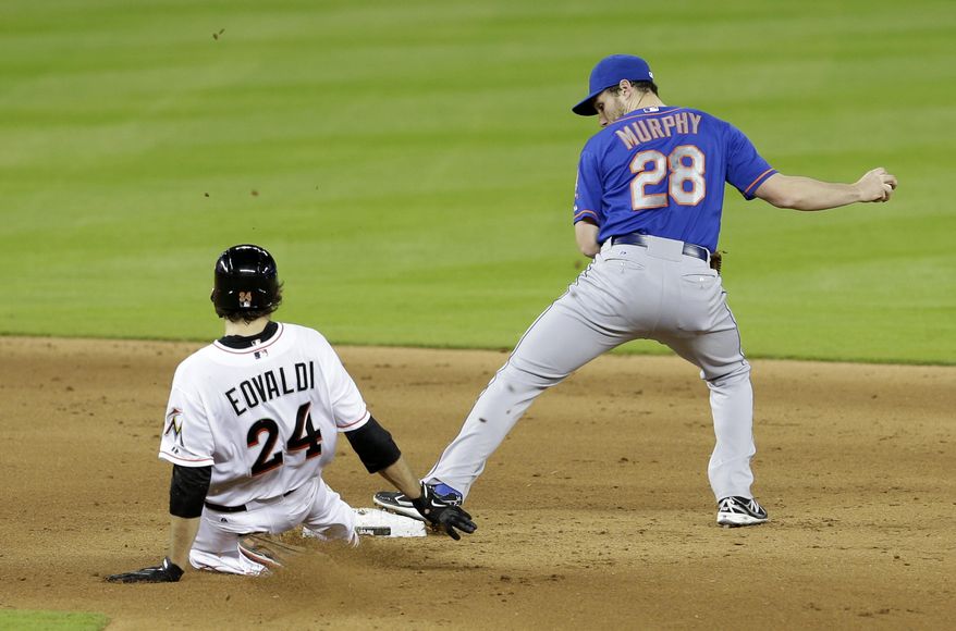 New York Mets second baseman Daniel Murphy (28) forces out Miami Marlins' Nate Eovaldi (24) on a fielder's choice during the fifth inning of a baseball game in Miami, Monday, May 5, 2014. (AP Photo/Alan Diaz)