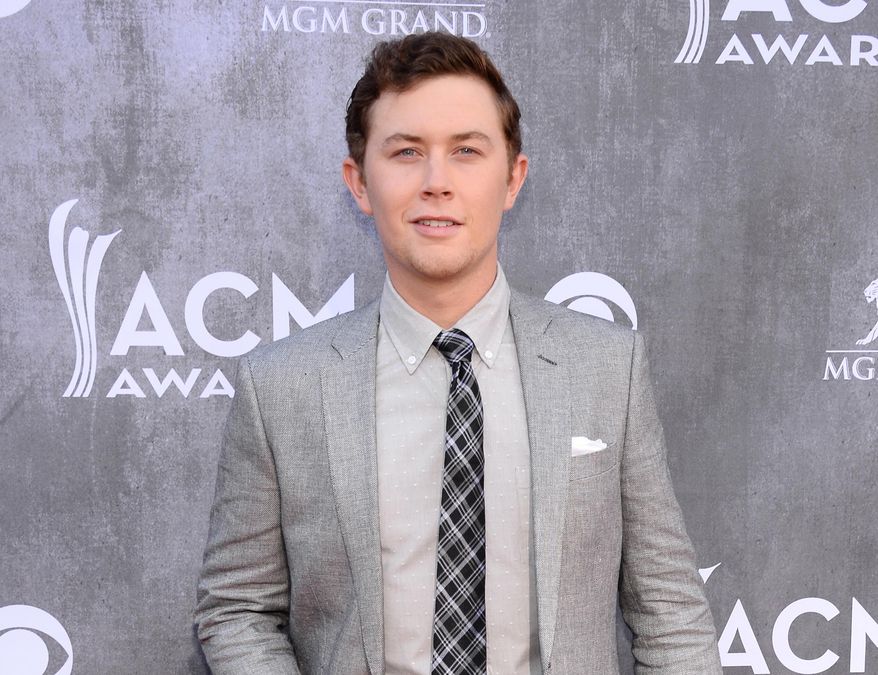 FILE - This April 6, 2014 file photo shows singer Scotty McCreery at the 49th annual Academy of Country Music Awards in Las Vegas. Police say McCreery was the victim of an early morning home invasion near the campus of North Carolina State University, where he is a student. Raleigh Police spokesman Jim Sughrue says officers were called shortly before 2 a.m. Monday, May 5, to an apartment about a mile from campus. Three suspects armed with guns are reported to have taken wallets, cash and electronic items. (Photo by Al Powers/Powers Imagery/Invision/AP, File)