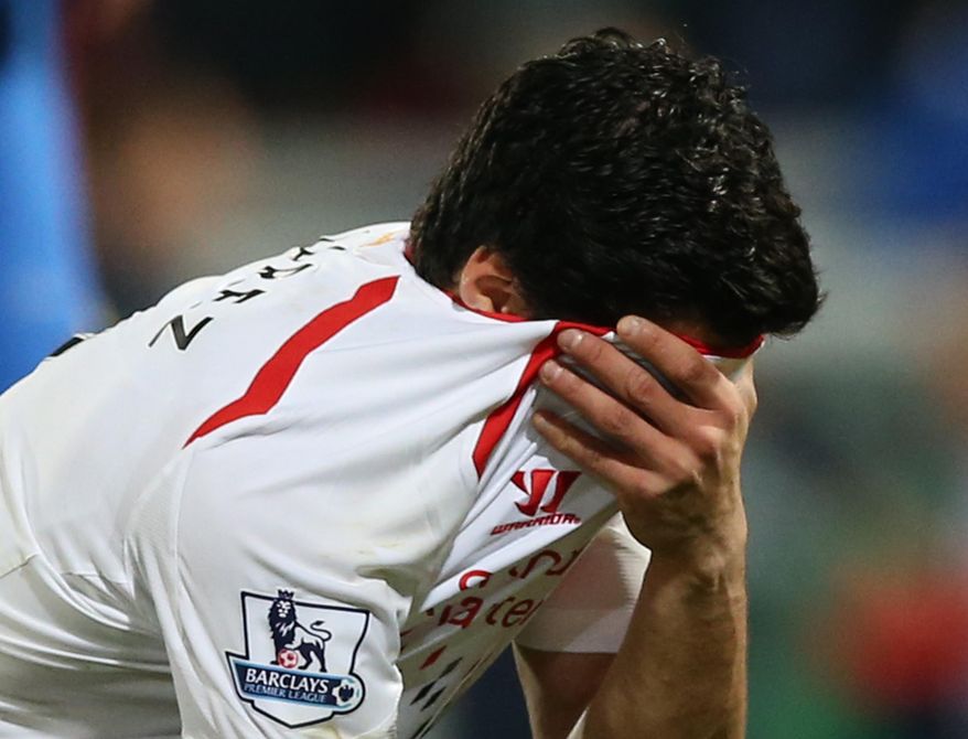Liverpool's Luis Suarez, holds his shirt to his face following the end of the English Premier League soccer match between Crystal Palace and Liverpool at Selhurst Park stadium in London, Monday, May 5, 2014. The game ended in a 3-3 draw. (AP Photo/Alastair Grant)