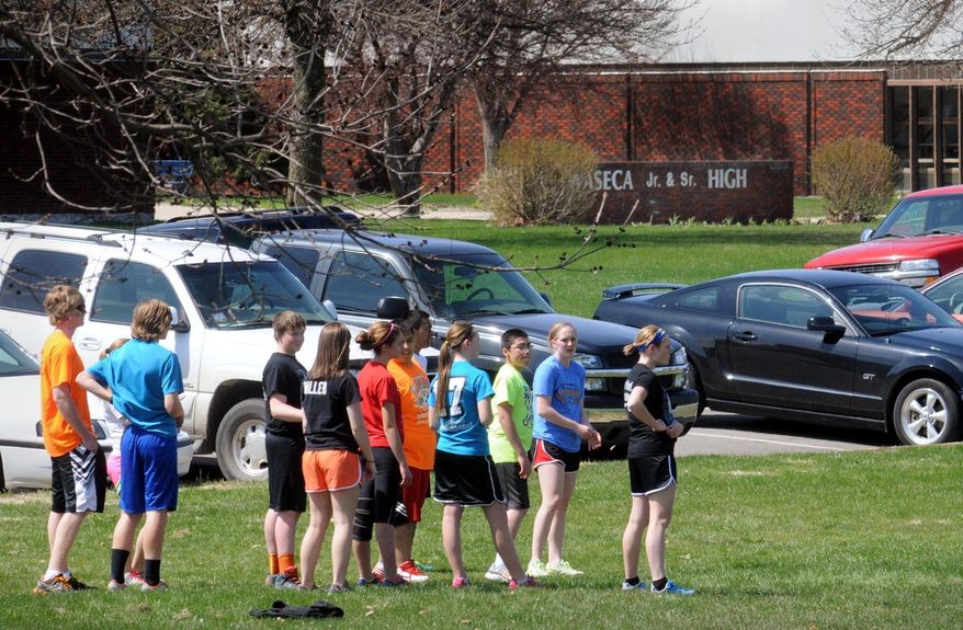 Students at the Waseca Junior and Senior High School in Waseca, Minn., participate in outdoor activities, Monday, May 5, 2014. A 17-year-old classmate was arrested last week, charged with plotting an attack on the school in south-central Minnesota. (AP Photo/The Mankato Free Press, John Cross)