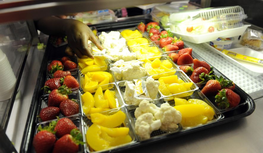 Fruit and vegetables are served during lunch service at the Patrick Henry Elementary School in Alexandria, Va., Tuesday, April 29, 2014. (AP Photo/Susan Walsh)