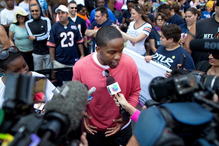 FILE - In this June 30, 2013 file photo, former NFL football player Wade Davis, grand marshal for the Chicago Gay Pride Parade, speaks to reporters prior to the parade in Chicago. One of the people enlisted to help advise All-American defensive end Michael Sam of Missouri before publicly announcing he was gay was Davis, a former NFL player who came out in 2012 - nine years after retiring. (AP Photo/Scott Eisen)