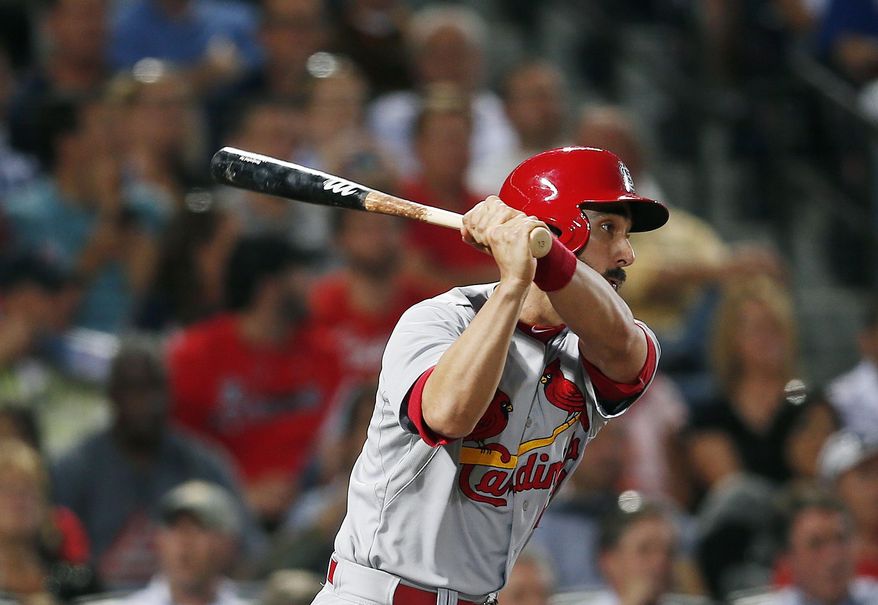 St. Louis Cardinals third baseman Matt Carpenter (13) follows through with a two-run double in the fifth inning of a baseball game against the Atlanta Braves Monday, May 5, 2014 in Atlanta. (AP Photo/John Bazemore)