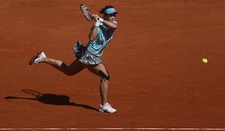 Na Li from China returns the ball during a Madrid Open tennis tournament match against Kirsten Flipkens from Belgium, in Madrid, Spain, Monday, May 5, 2014. (AP Photo/Andres Kudacki)