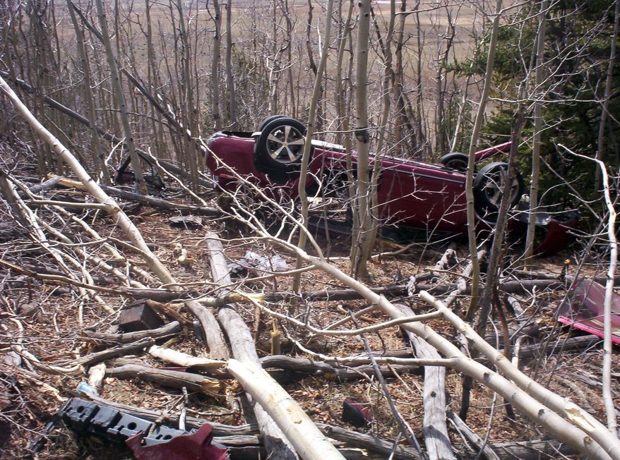 In this May 2014, photo provided by the Park County Sheriff’s Office, Kristin Hopkins' car is seen after she drove off the roadway near the old mining town of Fairplay, Colo., sometime after she was last seen on April 27. Authorities say at least one motorist hiked down from Red Hill Pass on U.S. Highway 285 and alerted authorities on Sunday, May 4, that there was a body inside the car. Rescuers found Hopkins alive, conscious and coherent — but critically injured and extremely dehydrated. (AP Photo/Park County Sheriff’s Office)