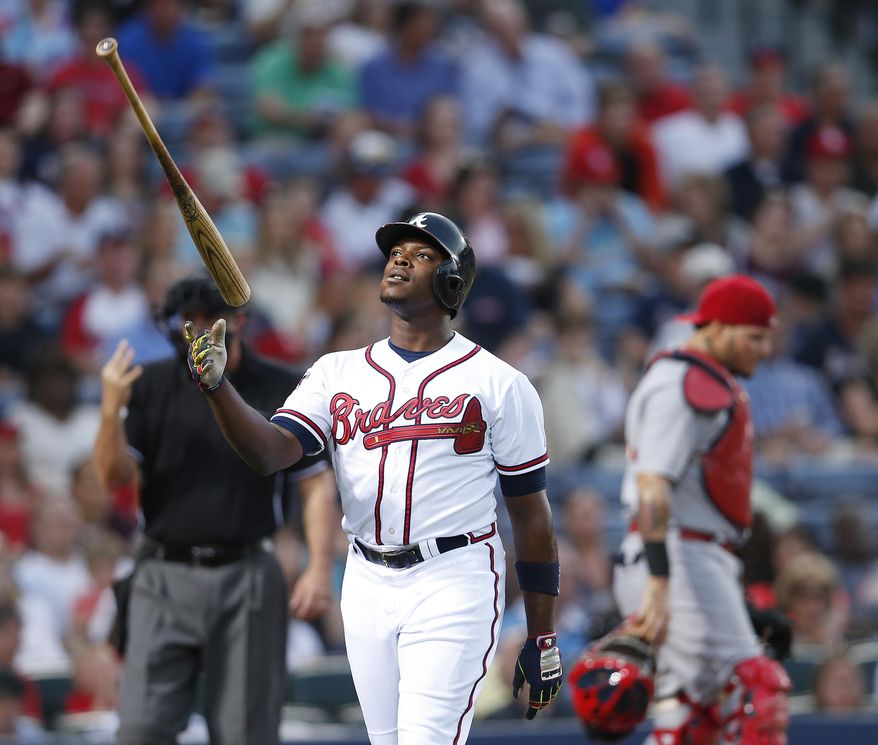 Atlanta Braves left fielder Justin Upton (8) flips his bat as he walks back to the dugout after striking out in the third inning of a baseball game against the St. Louis Cardinals Monday, May 5, 2014 in Atlanta. (AP Photo/John Bazemore)