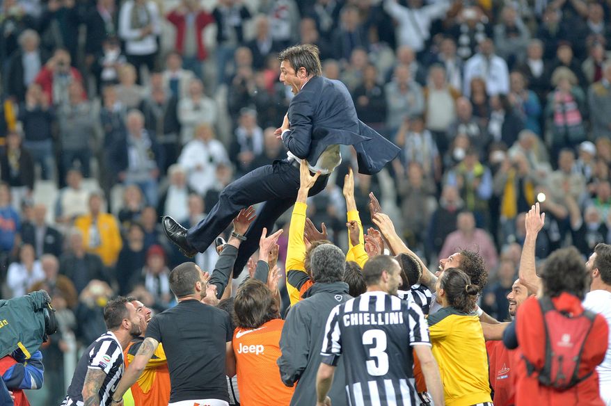 Juventus players lift their coach Antonio Conte as they celebrate at the end of a Serie A soccer match againsts Atalanta, at the Juventus stadium, in Turin, Italy, Monday, May 6, 2014. Juventus clinched its third straight and 30th overall Serie A title. (AP Photo/Massimo Pinca)