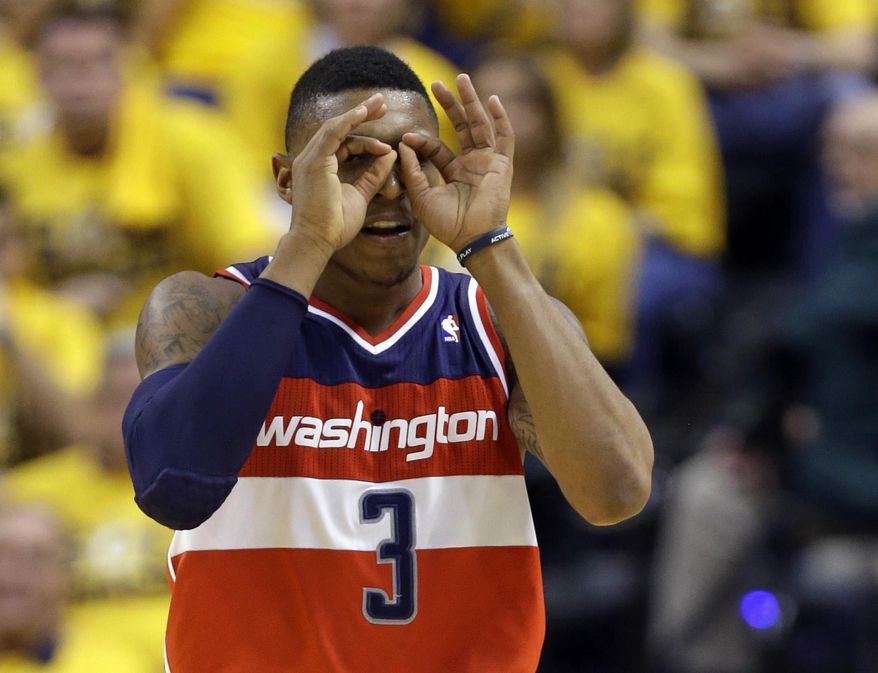 Washington Wizards guard Bradley Beal celebrates a three-point bucket against the Indiana Pacers during the second half of game 1 of the Eastern Conference semifinal NBA basketball playoff series in Indianapolis, Monday, May 5, 2014. The wizards defeated the Pacers 102-96. (AP Photo/Michael Conroy)