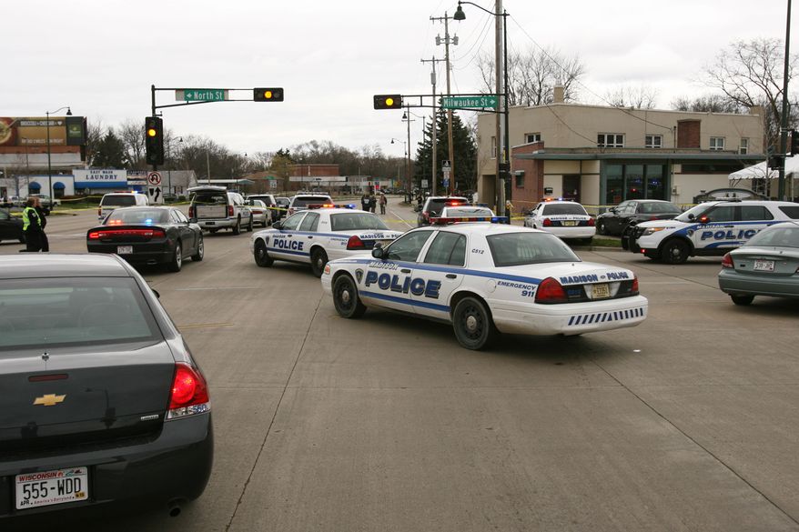 In a Friday, May 2, 2014, file photo, police investigate an area in Madison, Wis., where a mother and daughter were fatally stabbed in an apartment at 2617 E. Washington Ave. (AP Photo/Wisconsin State Journal, Amber Arnold) ** FILE **