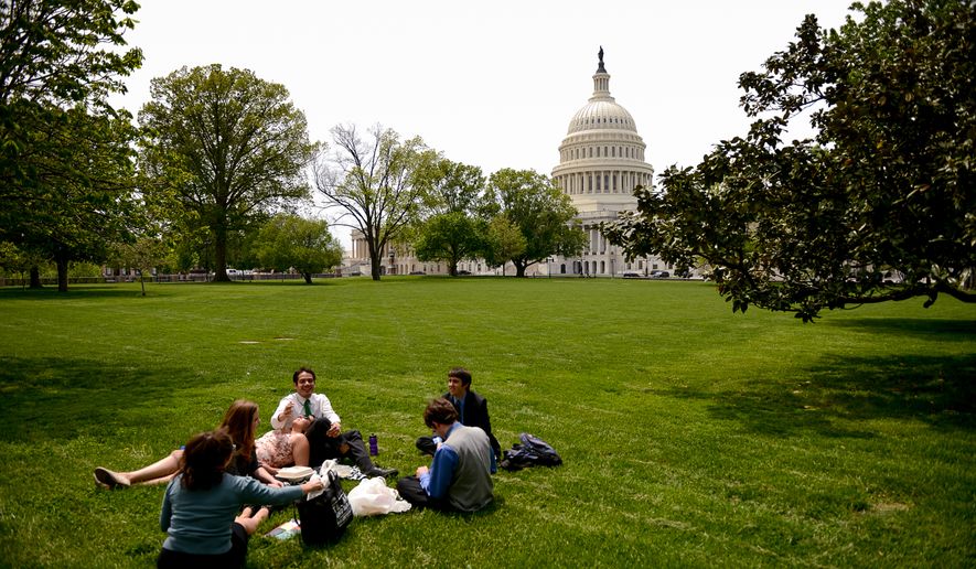Capitol Hill office workers take their lunch break on the grounds of the U.S. Capitol Building on a pleasant spring day, Washington, D.C., Monday, May 5, 2014. (Andrew Harnik/The Washington Times)