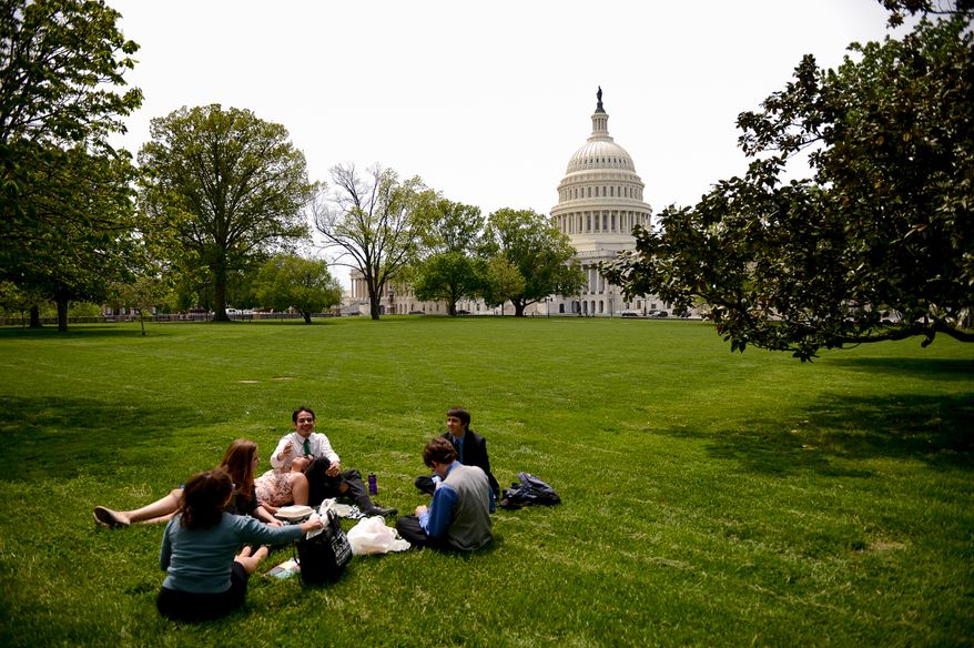 Capitol Hill office workers take their lunch break on the grounds of the U.S. Capitol Building on a pleasant spring day, Washington, D.C., Monday, May 5, 2014. (Andrew Harnik/The Washington Times)