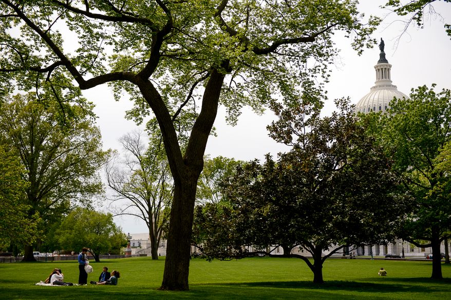 Capitol Hill office workers take their lunch break on the grounds of the U.S. Capitol Building on a pleasant spring day, Washington, D.C., Monday, May 5, 2014. (Andrew Harnik/The Washington Times)
