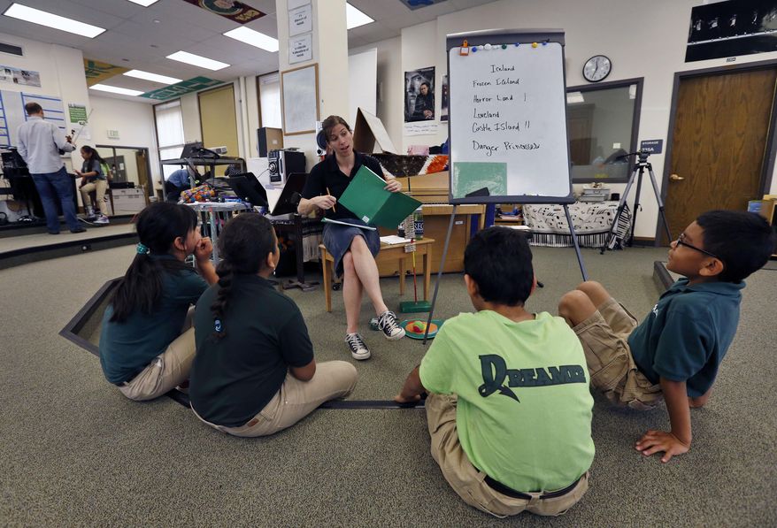 In this April 22, 2014 photo, teacher Celesta Cairns talks with students during music class, at Cole Elementary, in Denver. After years of promoting hefty education reforms, Colorado lawmakers this term focused on a school overhaul that was both more popular and more problematic, giving schools money to make the reforms and backfill years of recession-era cuts. (AP Photo/Brennan Linsley)