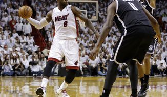 Miami Heat&#39;s LeBron James (6) looks to pass around Brooklyn Nets defender Andray Blatche (0) in the first half of Game 1 in an NBA Eastern Conference semifinal basketball series, Tuesday, May 6, 2014, in Miami. (AP Photo/Lynne Sladky)