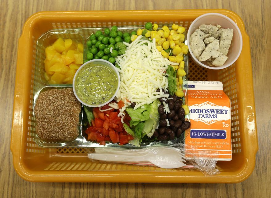 A school lunch salad entree option featuring low-sodium chicken, a whole-grain roll, fresh red peppers, and cilantro dressing is assembled in a lunch basket at Mirror Lake Elementary School in Federal Way, Wash., south of Seattle, Monday, May 5, 2014. On this day, students could choose between this salad and a more traditional lunch of a grilled cheese sandwich on whole grain bread served with a southwestern-style corn salad, fresh carrots and either canned pears or apple sauce. (AP Photo/Ted S. Warren)