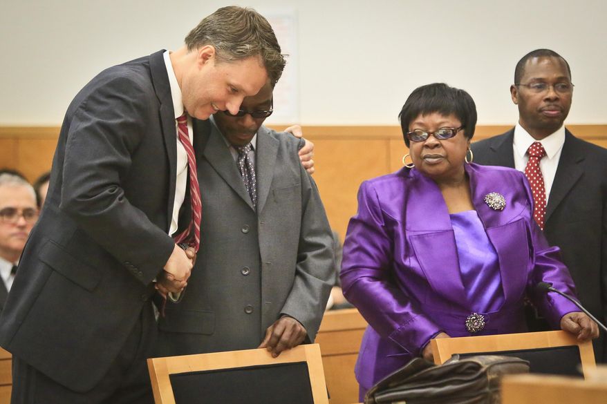 Attorney Pierre Sussman, far left, embraces his client Alvena Jennette, who stood with his mother Loiuse Austin, second from right, and her son Neter Kamani, far right, as Justice Neil Firetog declared him exonerated in Brooklyn Supreme Court, Tuesday May 6, 2014 in New York. Prosecutors in Brooklyn asked to throw out a decades-old convictions of three half-brothers who were investigated by homicide detective Louis Scarcella, whose tactics have come into question. The defendants, Jennette, Robert Hill and Darryl Austin became the first people connected to the detective to be exonerated. Louise Austin stood for son Darryl who died in prison. (AP Photo/Bebeto Matthews)