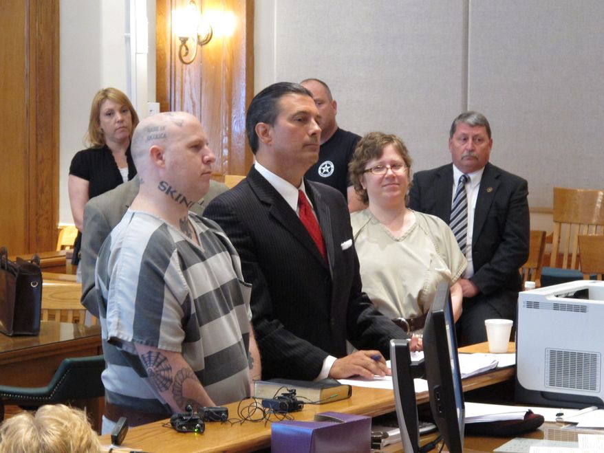 From left, Jeremy Moody, lawyer Harry Dest and Christine Moody appear before a judge as the Moody's get ready to plead guilty to murder on Tuesday, May 6, 2014, in Union, S.C. Prosecutors said the husband and wife killed Charles Parker in his home in July 2013 because he was a sex offender and his wife Gretchen Parker because she was there. (AP Photo/Jeffrey Collins)