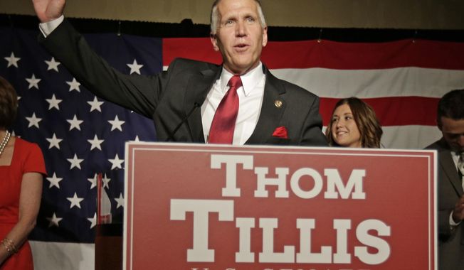 Thom Tillis waves to supporters at a election night rally in Charlotte, N.C., after winning the Republican nomination for the U.S. Senate Tuesday, May 6, 2014.  Tillis, the Republican establishment’s favored son in North Carolina, won the state’s Senate nomination by running as a proud conservative who’s not terribly different from his tea party and Christian-right opponents. (AP Photo/Chuck Burton)