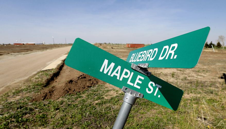 In this photo taken April, 18, 2014, street signs and stretches of roads are all that remain of a trailer park built by the Federal Emergency Management Agency to provide temporary housing for displaced residents displaced in Greensburg, Kan. Seven years after an EF-5 tornado destroyed most of the community of 1,500, Greensburg's population is around 850 residents. (AP Photo/Charlie Riedel)