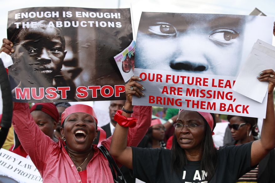 Women attend a demonstration calling on the government to rescue kidnapped school girls of a government secondary school Chibok, in Lagos, Nigeria, Monday May 5, 2014. Their plight — and the failure of the Nigerian military to find them — has drawn international attention to an escalating Islamic extremist insurrection that has killed more than 1,500 so far this year. Boko Haram, the name means "Western education is sinful," has claimed responsibility for the mass kidnapping and threatened to sell the girls. The claim was made in a video seen Monday. The British and U.S. governments have expressed concern over the fate of the missing students, and protests have erupted in major Nigerian cities and in New York. (AP Photo/Sunday Alamba)