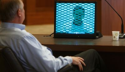 In this March 27, 2014, file photo, Lorin Holm, an exiled member of the Fundamentalist Church of Jesus Christ of Latter Day Saints, looks on as video of a deposition of FLDS Church leader Warren Jeffs is played for the court during a custody hearing between Holm and his two ex-wives who still belong to the FLDS Church in 5th District Court in St. George, Utah.  Several men exiled from Warren Jeffs' polygamous sect are warning a judge that requiring a man to pay his ex-wives' attorney fees after winning a recent custody suit would have a chilling effect on others who have been kicked out and want their children back.  (AP Photo/The Spectrum & Daily News,  Jud Burkett, Pool, File)