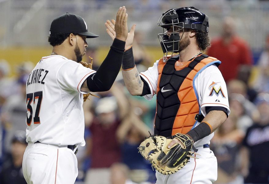 Miami Marlins starting pitcher Henderson Alvarez, left, celebrates with catcher Jarrod Saltalamacchia as the Marlins defeated the New York Mets 3-0 in a baseball game, Tuesday, May 6, 2014, in Miami. Alvarez pitched a six-hitter for his second shutout this season. (AP Photo/Wilfredo Lee)