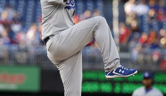 Los Angeles Dodgers starting pitcher Clayton Kershaw throws during the first inning of a baseball game against the Washington Nationals at Nationals Park, Tuesday, May 6, 2014, in Washington. (AP Photo/Alex Brandon)