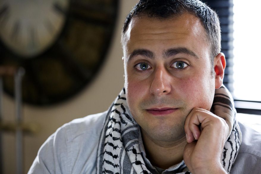 In this Sunday, May 4, 2014 photo, Bashar Makhay poses for a photo in his apartment in the Brooklyn borough of New York. Makhay, who is Iraqi-American, Chaldean Catholic and gay, says he created Tarab, a series of parties, beach gatherings and other events for LGBT Arabs and Middle Easterners in New York City. The Tarab program will celebrate its second anniversary with an event May 10. (AP Photo/Craig Ruttle)