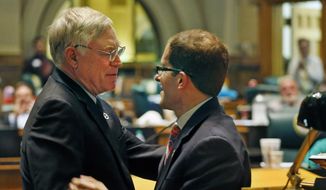 Democratic House Speaker Rep. Mark Ferrandino, right, hugs his Republican colleague Rep. Bob Gardner, following a tribute to Gardner&#39;s service in the state house, on the last day of the Spring session at the Colorado Legislature, in Denver, Wednesday, May 7, 2014. Both men are outgoing representatives. Banking for marijuana businesses and property tax forgiveness for disaster victims headlined the final day of the Colorado Legislature on Wednesday, though the last hours were lacking the drama of many past sessions.  (AP Photo/Brennan Linsley)