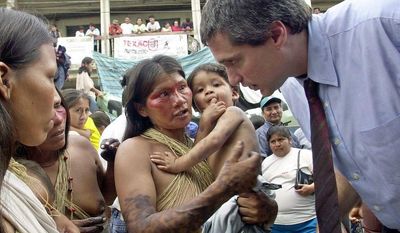 Lawyer Steven Donziger, right, speaks to  Huaorani women during this first day of the trial against Chevron-Texaco, in Lago Agrio, Tuesday, Oct. 21, 2003. A decade after Texaco pulled out of the Amazon jungle, the U.S. petroleum giant went on trial Tuesday in a lawsuit filed on behalf of 30,000 poor Ecuadoreans who say the company&#39;s 20 years of drilling poisoned their homeland.  (AP Photo/Dolores Ochoa)