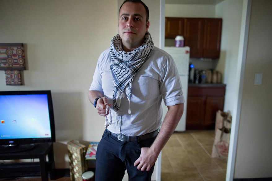 In this Sunday, May 4, 2014 photo, Bashar Makhay pauses in his apartment in the Brooklyn borough of New York. Makhay, who is Iraqi-American, Chaldean Catholic and gay, says he has created Tarab, a series of parties, beach gatherings and other events for LGBT Arabs and Middle Easterners in New York City. The Tarab program will celebrate its second anniversary with an event May 10. (AP Photo/Craig Ruttle)