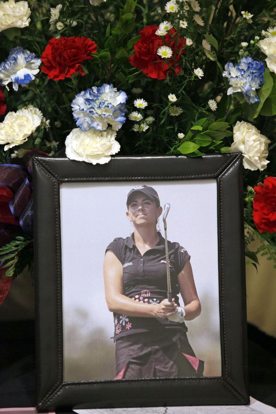 FILE - This May 19, 2010 file photo shows a portrait of LPGA golfer Erica Blasberg displayed at her memorial service at Eagle Glen Golf Club in Corona, Calif. Jury selection is entering a third day in Las Vegas Wednesday, May 7, 2014, in a civil wrongful death and medical malpractice lawsuit against a Nevada physician who found the body of women’s professional golfer Blasberg after she committed suicide in May 2010. Dr. Thomas Hess pleaded guilty in late 2010 to a misdemeanor obstruction charge for removing a suicide note and prescription medications from Blasberg's home in Henderson before police arrived to investigate her death. Blasberg’s father, Mel Blasberg, accuses the 46-year-old Hess of having an inappropriate personal relationship with the 25-year-old golfer, and of failing to provide proper medical care before she died. (AP Photo/Nick Ut)