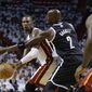 Miami Heat&#39;s Chris Bosh, left, passes as Brooklyn Nets&#39; Kevin Garnett (2) defends in the first half of Game 1 in an Eastern Conference semifinal basketball game, Tuesday, May 6, 2014, in Miami. The Heat defeated the Nets 107-86. Bosh scored 15 points and grabbed 11 rebounds. (AP Photo/Lynne Sladky)
