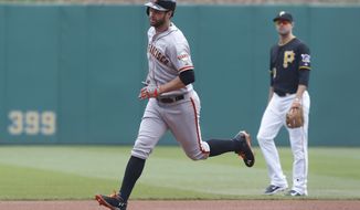 San Francisco Giants&#39; Brandon Belt, left, rounds the bases past Pittsburgh Pirates second baseman Neil Walker after hitting a home run in the first inning of a baseball game on Wednesday, May 7, 2014, in Pittsburgh.  (AP Photo/Keith Srakocic)