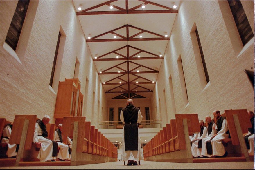 FILE - In this July 3, 1998 file photo, Trappist monks observe their first group prayer of the day called Vigils at 3:15 a.m. in Trappist, Ky. Within the walls of the Chapel at the Abbey of Gethsemani the monks read scripture and chant as they begin their day. Police said John Hutchins, an accountant, began diverting money from an account at the Abbey of Gethsemani near Bardstown in 2008. Hutchins and his wife, Carrie Hutchins, were indicted by a grand jury, Wednesday, May 7, 2014, on multiple counts of felony theft over and under $10,000 and unlawful access to a computer, said Nelson County Sheriff's Detective Jason Allison. He said they were also charged with complicity to commit theft, which "means it was two people working together." (AP Photo/Tony Gutierrez)