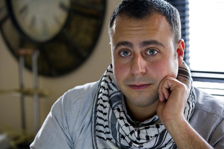 In this Sunday, May 4, 2014 photo, Bashar Makhay poses for a photo in his apartment in the Brooklyn borough of New York. Makhay, who is Iraqi-American and gay, said he created Tarab, a series of parties, beach gatherings and other events for LGBT Arabs and Middle Easterners in New York City. The Tarab program will celebrate its second anniversary with an event May 10. (AP Photo/Craig Ruttle)