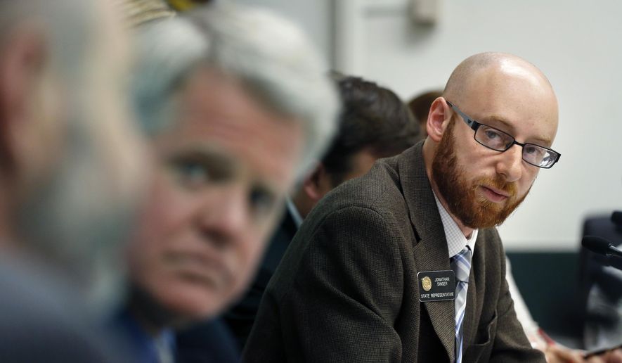 Rep. Jonathan Singer, D-Longmont, listens to discussion on a bill he sponsored which would allow marijuana dispensaries to form financial co-operatives, at the Colorado Legislature, in Denver, Wednesday May 7, 2014. (AP Photo/Brennan Linsley) ** FILE **