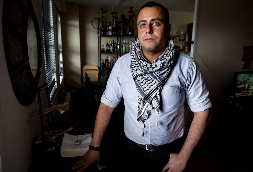 In this Sunday, May 4, 2014 photo, Bashar Makhay stands for a photo in his apartment in the Brooklyn borough of New York. Makhay, who is Iraqi-American, Catholic and gay, said he created Tarab, a series of parties, beach gatherings and other events for LGBT Arabs and Middle Easterners in New York City. The Tarab program will celebrate its second anniversary with an event May 10. (AP Photo/Craig Ruttle)