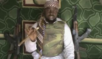 FILE - This file image made available Wednesday, Jan. 10, 2012, taken from video posted by Boko Haram sympathizers, shows the leader of the radical Islamist sect Imam Abubakar Shekau. Boko Haram has claimed responsibility for the April 15, 2014, mass abduction of nearly 300 teenage schoolgirls in northeast Nigeria. Even before the kidnapping, the U.S. government was offering up to a $7 million reward for information leading to the arrest of Shekau, whom the U.S. has labeled a specially designated global terrorist. (AP Photo/File)