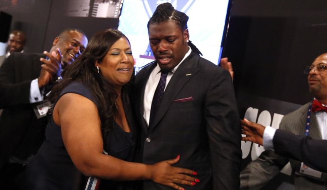 Jadeveon Clowney, from South Carolina, reacts with his mother Josenna Clowney after being selected first overall by the Houston Texans in the first round of the NFL football draft, Thursday, May 8, 2014, at Radio City Music Hall in New York. (AP Photo/Jason DeCrow)