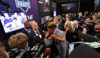 Odell Beckham, Jr., from LSU, is congratulated after being selected 12th overall by the New York Giants in the first round of the NFL football draft, Thursday, May 8, 2014, at Radio City Music Hall in New York. (AP Photo/Jason DeCrow)