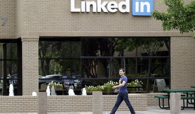 A man walks past the LinkedIn headquarters in Mountain View , Calif. on Thursday, May 8, 2014. (AP Photo/Marcio Jose Sanchez)