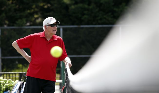 Marty Dowd, tennis coach for Catholic University of America, watches practice, Thursday, May 8, 2014 in Washington. The 77-year-old coach led the Cardinals to the Landmark Conference title and a first-round match against Washington &amp;amp; Lee in the NCAA Division III bracket. (AP Photo/Alex Brandon)