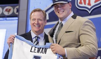 Michigan outside tackle Taylor Lewan poses for photos with NFL commissioner Roger Goodell after being selected by the Tennessee Titans as the eleventh pick in the the first round of the 2014 NFL Draft, Thursday, May 8, 2014, in New York. (AP Photo/Craig Ruttle)