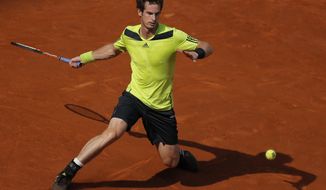 Andy Murray from Britain returns the ball during a Madrid Open tennis tournament match against Santiago Giraldo from Colombia in Madrid, Spain, Thursday, May 8, 2014. (AP Photo/Andres Kudacki)
