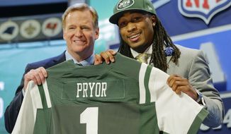 Louisville free safety Calvin Pryor poses with NFL commissioner Roger Goodell after being selected by the New York Jets as 18th pick in the the first round of the 2014 NFL Draft, Thursday, May 8, 2014, in New York. (AP Photo/Craig Ruttle)