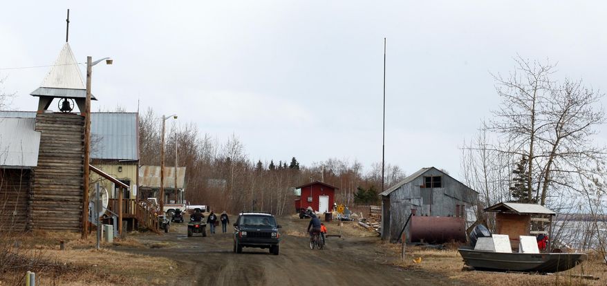 Residents make their way along First Street in the village of Tanana, Alaska Wednesday, May 7, 2014. Nathanial Lee Kangas, 20 of Tanana, was arrested for the murder of Alaska State Trooper Sergeant Patrick “Scott” Johnson and Trooper Gabriel “Gabe” Rich during an altercation the troopers were having with Kangas's father Arvin Kangas last week. The five members present on the seven-member Tanana Tribal Council voted unanimously at a meeting Tuesday night on a lifetime banishment of Arvin Kangas and William Walsh. (AP Photo/Fairbanks Daily News-Miner, Eric Engman)