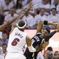 Brooklyn Nets forward Paul Pierce (34) looks for an open teammate past Miami Heat forward LeBron James (6) and center Chris Bosh, left, during the first half of Game 2 of an Eastern Conference semifinal basketball game, Thursday, May 8, 2014 in Miami. (AP Photo/Wilfredo Lee)