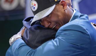 Ohio State outside linebacker Ryan Shazier hugs NFL commissioner Roger Goodell after being selected by the Pittsburgh Steelers as the 15th pick in the first round of the 2014 NFL Draft, Thursday, May 8, 2014, in New York. (AP Photo/Craig Ruttle)